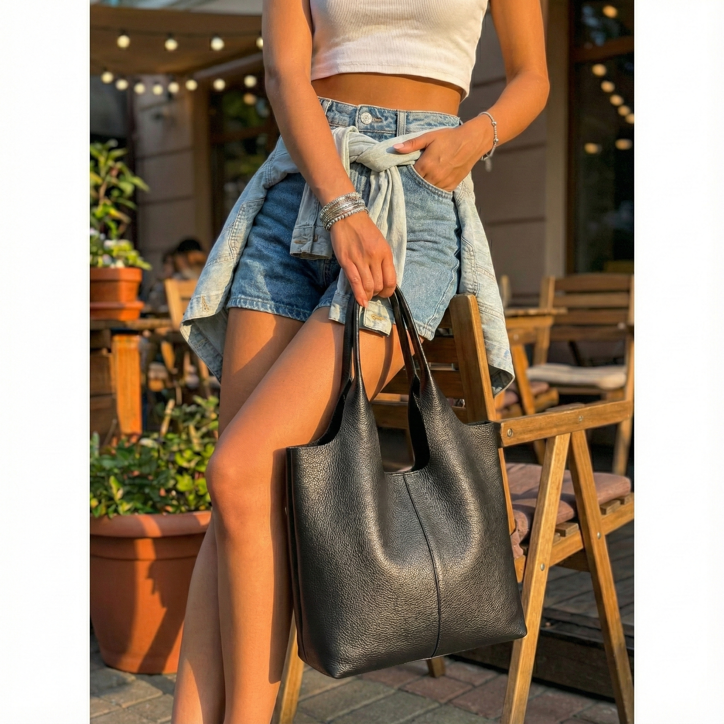Mujer usando bolso tote de uso diario cuero negro diseño vertical moderno